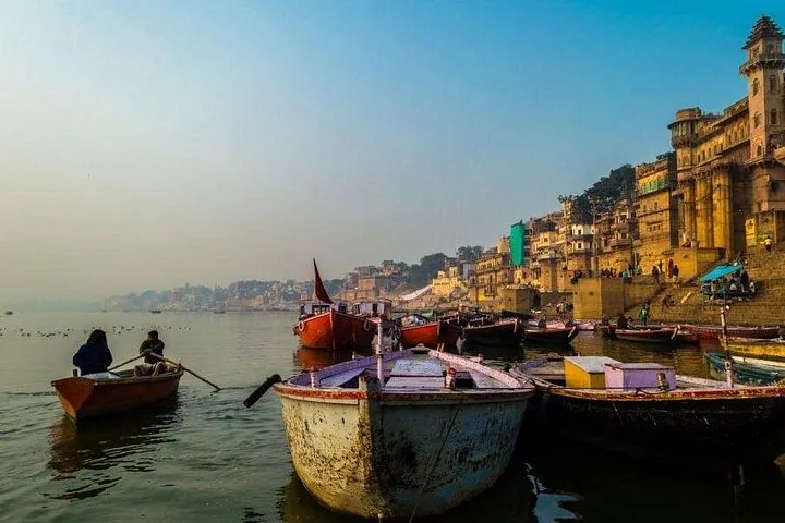Boats on the Ganges River with the Varanasi ghats in the background.